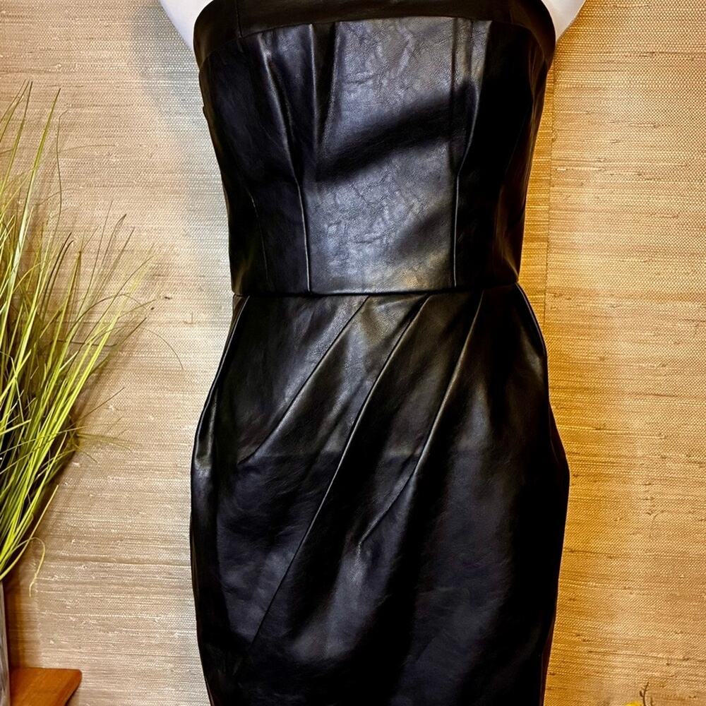 Elegant Black Strapless Mini Dress with snakeskin coat and necklace.